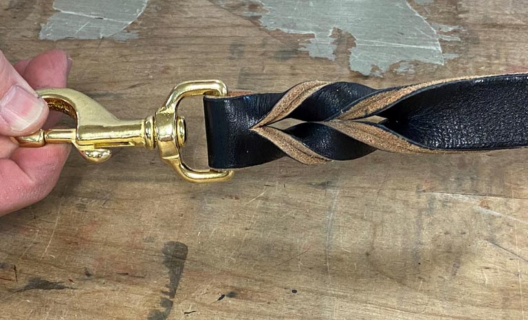 Braided leather leash weave completed on dog leash clip end.