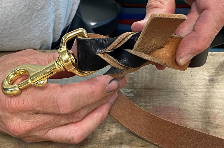 Weaving the leather around the barrel swivel snap.