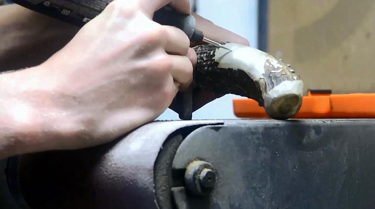 A Dremel tool engraves the knife handle