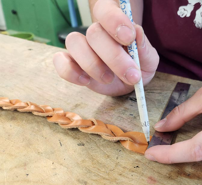 Marking  the snap hole's location in the leather.