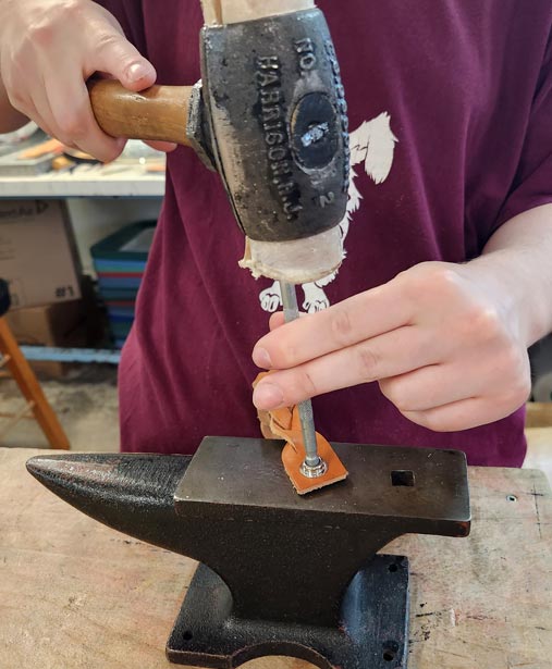 Setting the snap on an anvil.