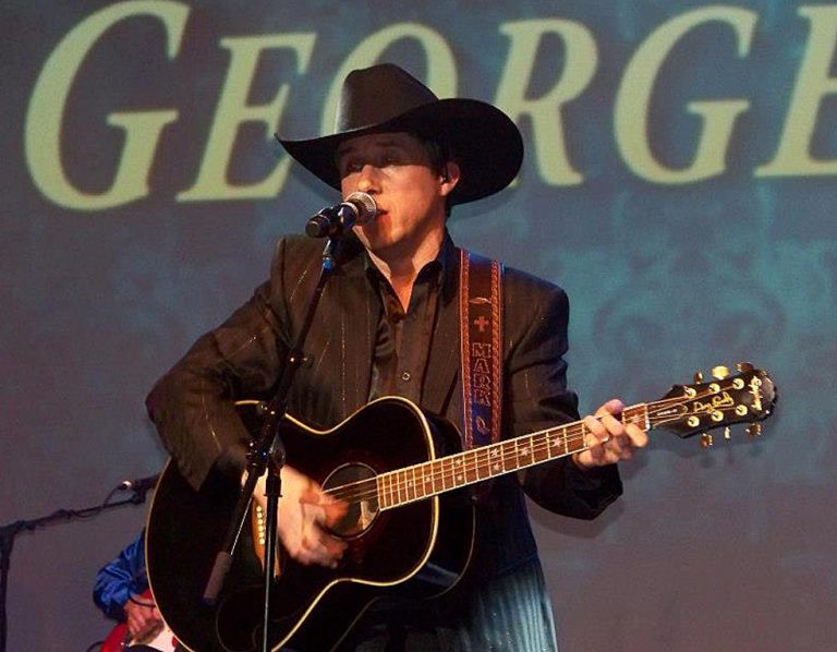 Mark Rankin performs wearing a hand tooled guitar strap