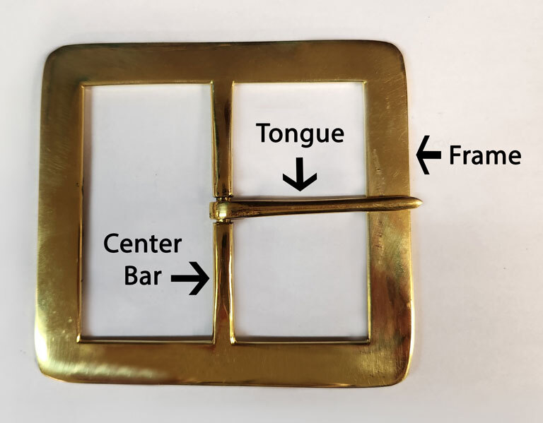 Parts of a center bar buckle. Parts of center bar buckle including tongue and frame.