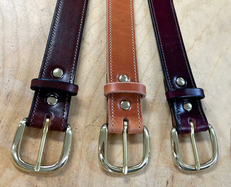 Solid brass heel bar buckles with leather keepers. Solid brass heel bar buckles on solid full grain leather belt.